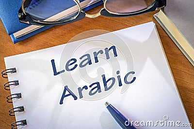 Learn arabic written in a notepad Stock Photo