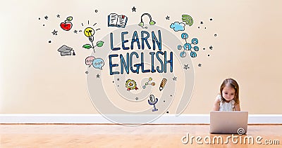 Learn English text with little girl using a laptop computer Stock Photo