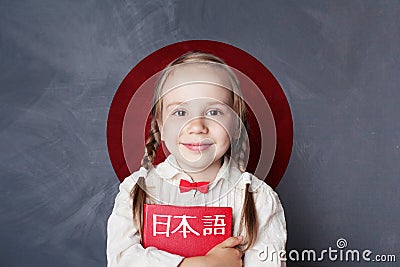 Learn japanese language. Smiling kid pupil on Japan flag Stock Photo