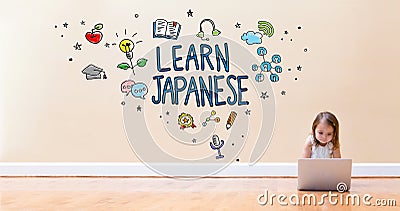 Learn Japanese text with little girl using a laptop computer Stock Photo