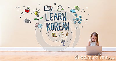 Learn Korean text with little girl using a laptop computer Stock Photo