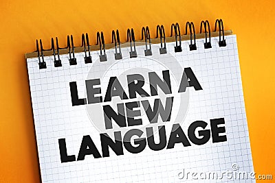 Learn A New Language text quote on notepad, concept background Stock Photo