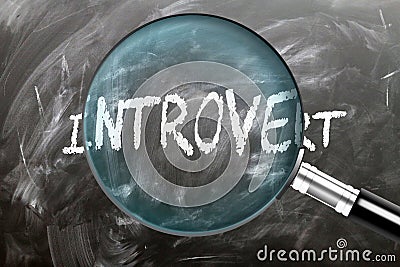 Learn, study and inspect Introvert. A magnifying glass enlarging word 'introvert' written on a blackboard Stock Photo