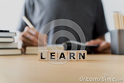 LEARN wording with book or textbook and pencil. Growth idea of business working and education learning success. Businessperson and Stock Photo