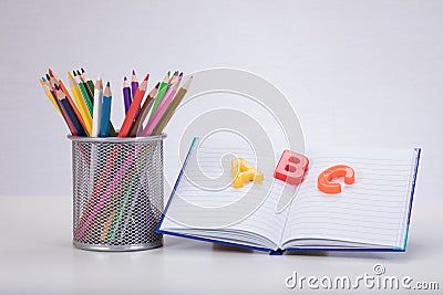 Learning concept with letters, book and pencils Stock Photo