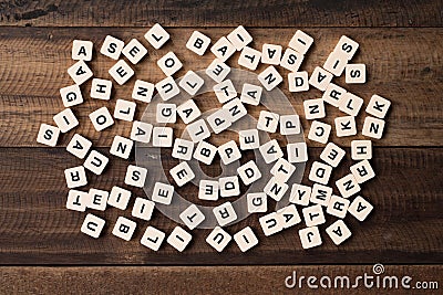 Learning and education concept - alphabet tiles / blocks on wooden background Stock Photo