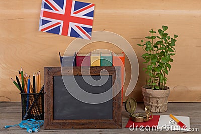 Learning english language concept - blank blackboard, flag of the United Kingdom, books, pencils, compass Stock Photo