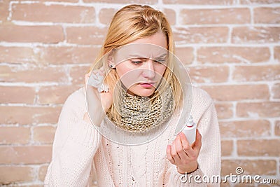 Learning how to use it. Suffering from asthma or allergic rhinitis. Cute woman nursing nasal cold or allergy. Sick woman Stock Photo