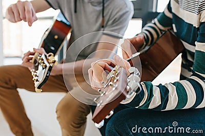 Learning to play the guitar. Music education and extracurricular lessons. Stock Photo