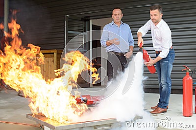 Learning to use fire extinguisher Stock Photo