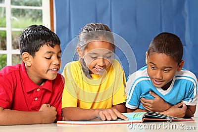 Learning together three happy young school kids Stock Photo