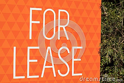 For lease sign on an orange display outside of a resedential building house in Australia. renting and investment property real Stock Photo