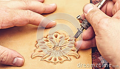 Leather artisan craftsman drawing an ornament Stock Photo