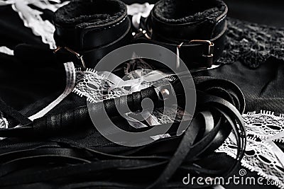 Leather black whip and handcuffs for domination and hard sex Stock Photo