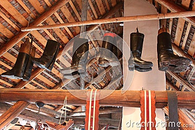 Leather boots hanging from the beam Stock Photo