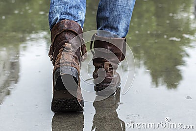 Leather boots on a wet sidewalk in the rain. Stock Photo