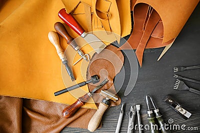 Leather with craft tools on dark wooden background Stock Photo