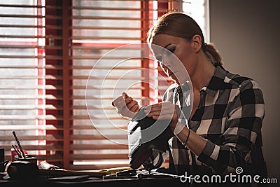 Leather handbag craftsman at work in a vintage workshop. Small business concept Stock Photo