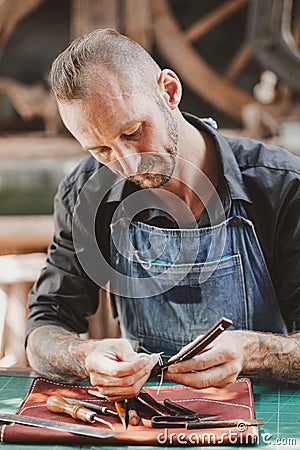 Leather maker artist handcraft working at own workshop small studio made by order masterwork piece Stock Photo