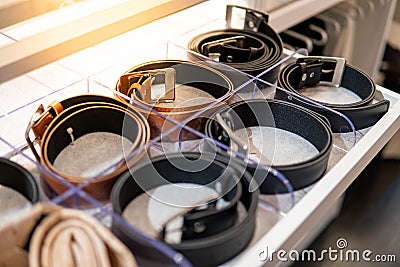 Leather rolled belt in drawer of walk-in closet Stock Photo