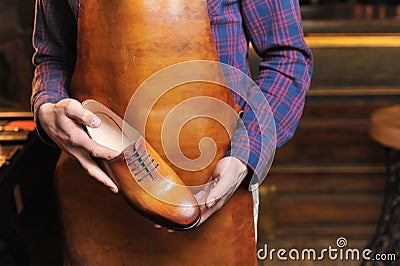 Leather shoes in the hands of the master Stock Photo