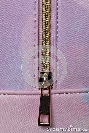 Leather texture background. Closeup of a detail of a luxury pink leather backpack with a closed metal lock zipper. Macro Stock Photo