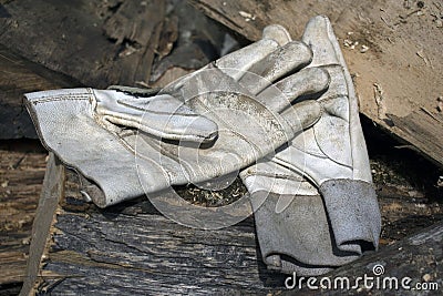 Leather working gloves on a pile of stumps Stock Photo