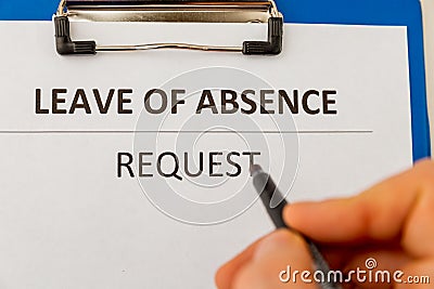 Leave of absence request on the tablet at the table. Stock Photo