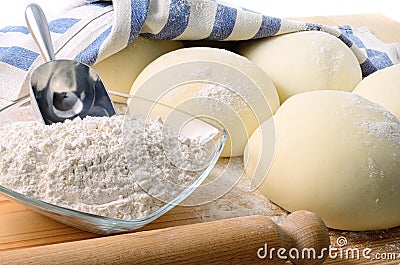 Leavened dough for pizza on a pastry board, closeup. Stock Photo