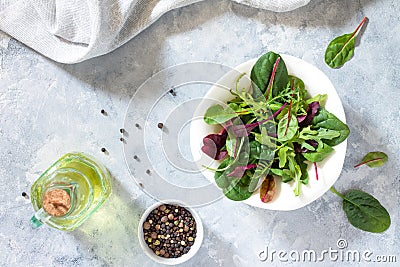 Leaves mix salad, spinach and arugula on a gray stone background. Stock Photo