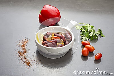 Lebanese starters of Sujok meat marinated, sausages fried in a frying pan Stock Photo