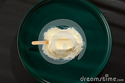 A leben or yoghourt flavor popsicle in a melting process in the shade of a window Stock Photo