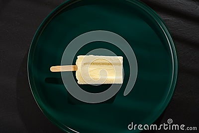 a leben or yoghourt flavor popsicle in the shade of a window Stock Photo