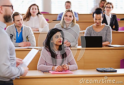 Lecturer and multinational group of students in an auditorium Stock Photo