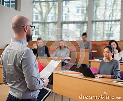 Lecturer and multinational group of students in an auditorium Stock Photo