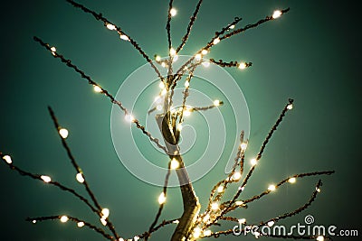 LED lamp tree against a green background. Luminous sparkling branches with many ramifications Stock Photo