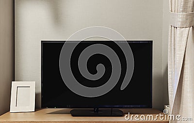 LED TV with blank black screen on built in shelf in living room Stock Photo