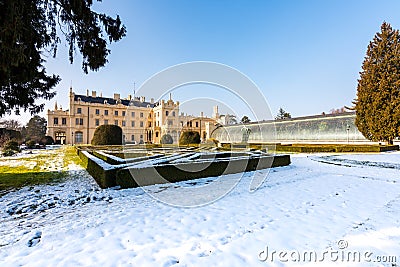 Lednice castle and greenhouse, snow and winter. Blue sky Stock Photo