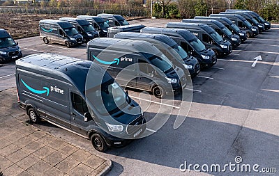 Row of new Ford E-Transit vans with Amazon Prime livery Editorial Stock Photo