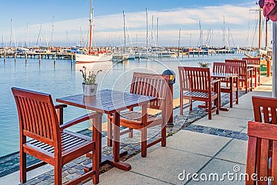 mpty restaurant table in the old harbour of WarnemÃ¼nde Stock Photo