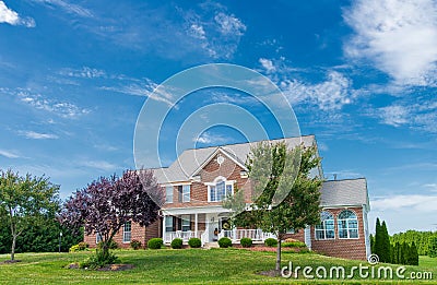 Country modern mansion in traditional American style. large green lawn and trees Editorial Stock Photo