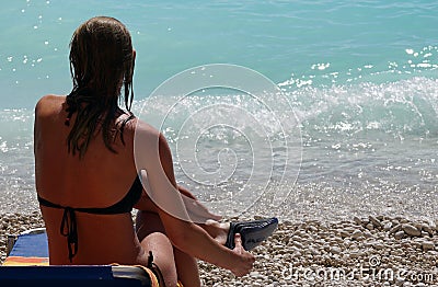 Lefkada, Greece, 16 July 2018, A beautiful woman admires the turquoise sea of Porto Katsiki, Lefkas Editorial Stock Photo