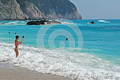 Lefkada, Greece July 16 2018, A tourist relaxes on the beach and the sea of Porto Katsiki Editorial Stock Photo