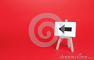 Left arrow easel sign. Direction pointer. Hint, help in navigation. Minimalism. Advertising and attracting attention. Redirecting Stock Photo