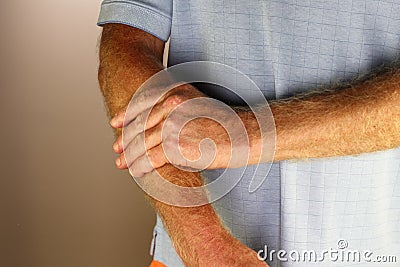 Left Hand and Fingers of an Adult White Male Massaging His Forearm Stock Photo