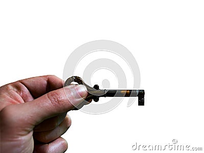 Concept of left hand holding old, metal key on white background with free space for text Stock Photo