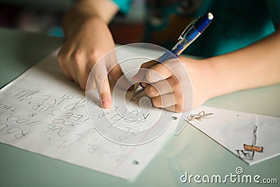 Left handed boy writing Stock Photo