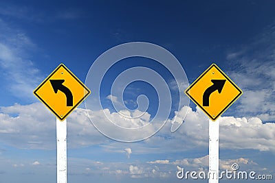 Left and right turn warning sign with blue sky Stock Photo