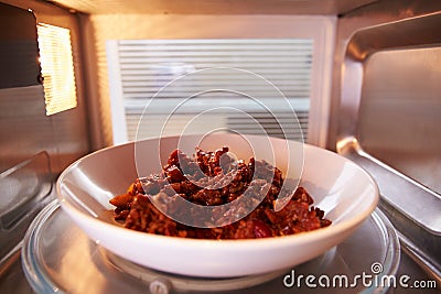 Leftover Chili Cooking Inside Microwave Ovenï¿½ Stock Photo