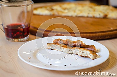 Leftovers of pizza dough and red tea on a table in cafe, food ending concept, cancellation of cafe visit Stock Photo